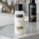 A white TRESemme Luxurious Moisture Conditioner bottle on a counter.
