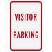 A white sign with red text that says "Visitor Parking" in white.
