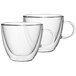 Two clear glass Villeroy & Boch cups with handles.