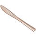 A close up of a rose gold Visions plastic knife.