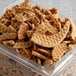 A plastic container of Lancaster Stroopies Company Cinnamon Stroopwafel wafer cookie pieces.