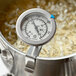 A Comark Candy / Deep Fry Probe Thermometer in a pot of boiling liquid.