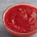 A bowl of Les Vergers Boiron strawberry puree on a white background.