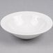 A Tuxton Alaska bright white china grapefruit bowl on a white surface.