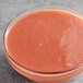 A bowl of pink Les Vergers Boiron Pink Guava puree on a table.