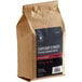 A brown bag of Crown Beverages Emperor's Finest Decaf Coarse Ground Coffee with a label.
