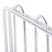 A close-up of a Metro stainless steel wire shelf divider on a metal rack.