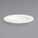 A white Front of the House porcelain saucer with a small rim on a gray surface.