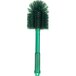 A close-up of a Carlisle green cleaning brush with bristles.
