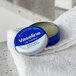 A small round Vaseline Lip Therapy container.