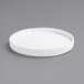 A Front of the House Soho bright white porcelain plate with a raised rim on a gray surface.