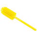 A yellow plastic Carlisle Sparta bottle cleaning brush with bristles and a handle.