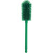 A close-up of a Carlisle Sparta green bottle cleaning brush with bristles.