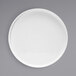 A white Front of the House Soho porcelain plate with a raised rim on a gray background.