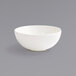 A Front of the House Catalyst European White Porcelain Bowl on a gray surface.