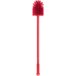 A red Carlisle Sparta multi-purpose cleaning brush with a red handle.