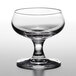 A Stolzle clear liqueur glass with a stem on a table.