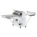 A large white and silver Estella floor dough sheeter with wheels.