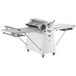 A white Estella floor dough sheeter with wheels and a handle.