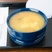 A blue Cambro entree bowl filled with soup on a tray.