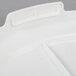 A white plastic lid with a curved top for a Rubbermaid ingredient container.