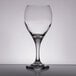 A close-up of a clear Libbey wine glass on a table.