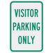 A green sign with white text that says "Visitor Parking Only"