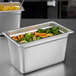 A Carlisle stainless steel steam table pan filled with broccoli, carrots, and corn.