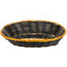 A black and gold oval rattan basket with a handle.