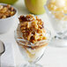 A bowl of ice cream with I. Rice walnut topping and nuts.