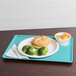 A Cambro robin egg blue dietary tray with food on it, including broccoli.