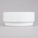 A white Arcoroc stackable bowl on a gray surface.