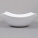 A white American Metalcraft square stoneware bowl with a curved edge on a gray background.