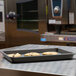 A Merrychef HardCoat quarter-size sheet pan with cookies on a counter.