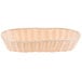 A beige woven rattan basket with handles.