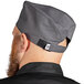 A man with a beard wearing a slate gray Uncommon Chef skull cap with a hook and loop closure.