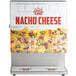 A Carnival King dual peristaltic cheese sauce and chili dispenser on a counter with a sign that says "Nacho Cheese" and a picture of nachos.