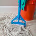 A blue Carlisle mop handle attached to a white mop.