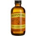 A close up of a 4 oz. bottle of Nielsen-Massey Pure Almond Extract.