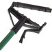 A green Carlisle mop handle with a black plastic head.
