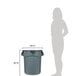 A woman standing next to a Rubbermaid grey plastic trash can.
