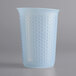 An OXO Good Grips translucent plastic measuring cup with a pattern on it.
