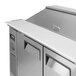A stainless steel Turbo Air refrigerated sandwich prep table with two doors on a counter.