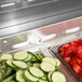 A Turbo Air refrigerated sandwich prep table with trays of sliced cucumbers and tomatoes.