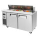 A Turbo Air 60" 2 door refrigerated sandwich prep table on a counter with food inside.