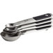 A stack of OXO stainless steel measuring spoons with black grips and a silver magnetic handle.