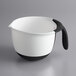 A white OXO measuring cup with a black handle and measurements.