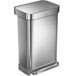 A simplehuman stainless steel rectangular front step-on trash can with a lid.