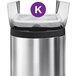 A silver stainless steel simplehuman trash can with a white custom fit liner with a purple circle.