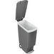 A simplehuman grey rectangular step-on trash can with a lid open.